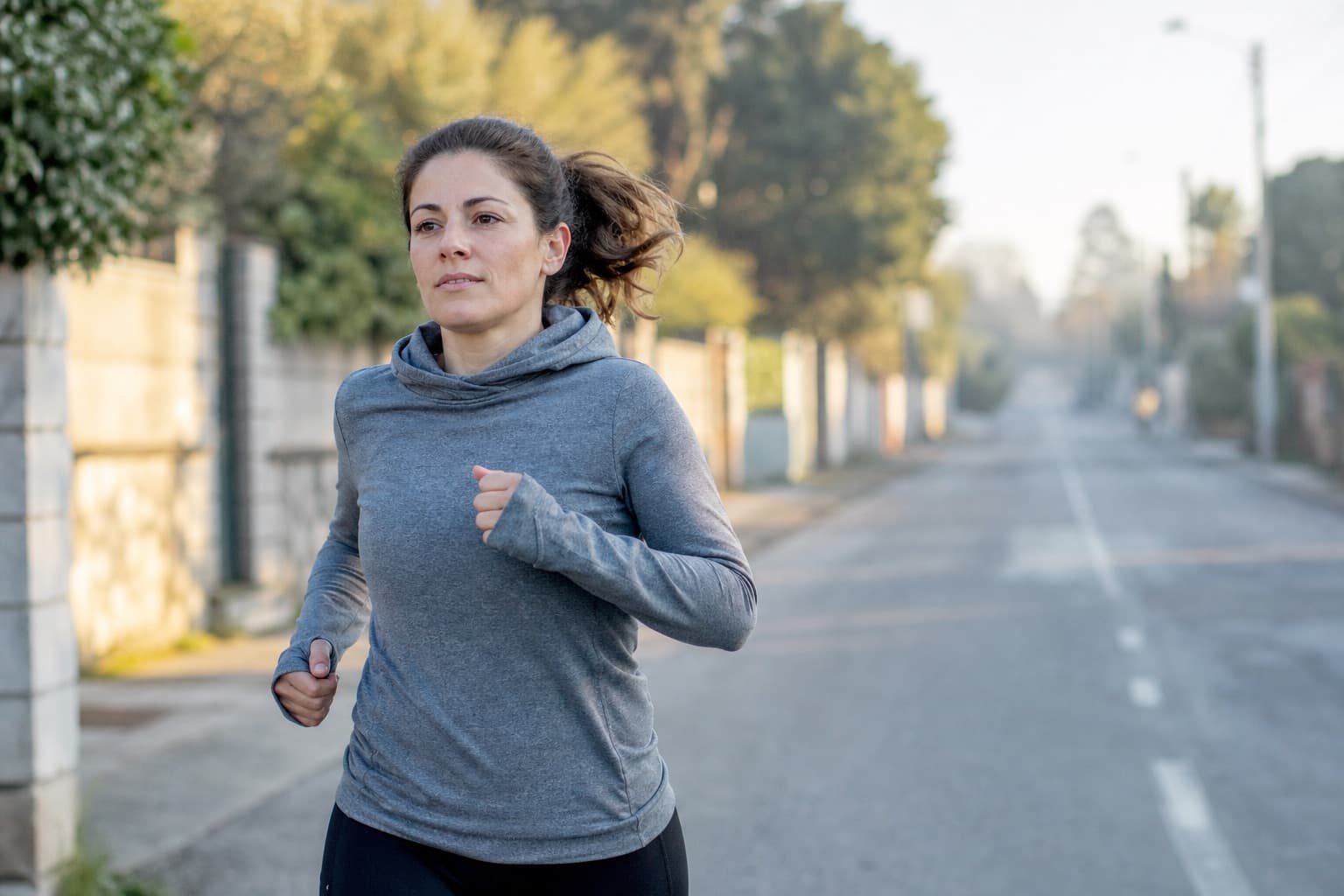 Beginner runner in ordinary clothing on a long training run outdoors.