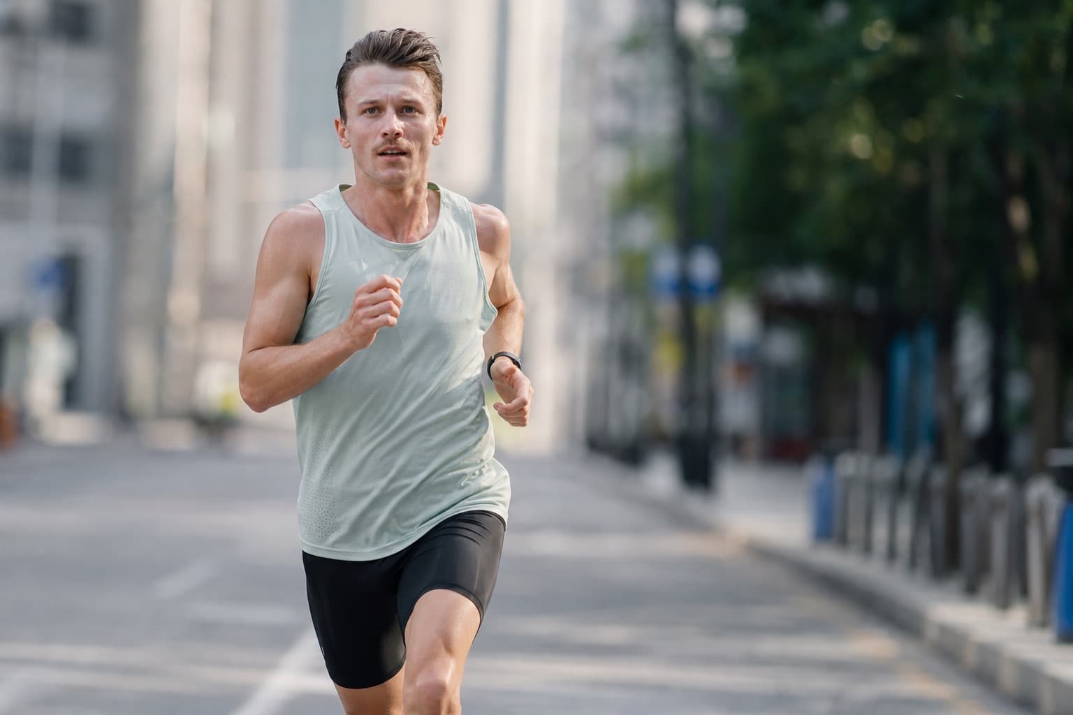 Runner in a fast, committed 5K effort on a city road.