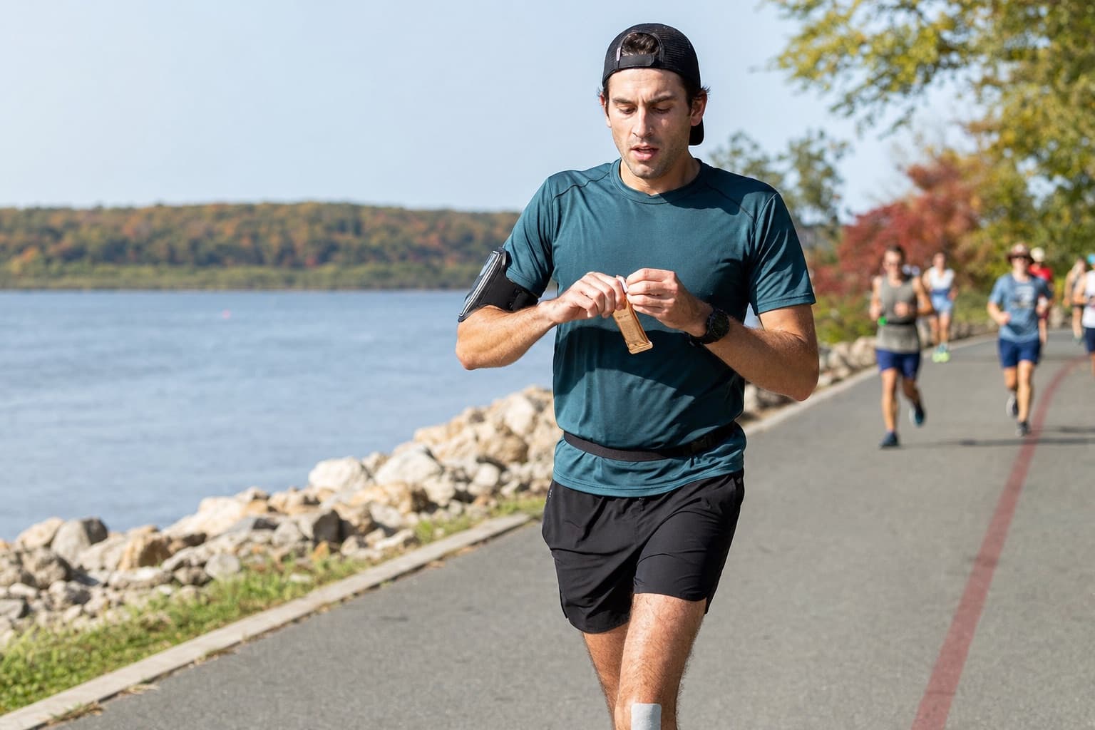 Half marathon runner taking an energy gel near the halfway point.