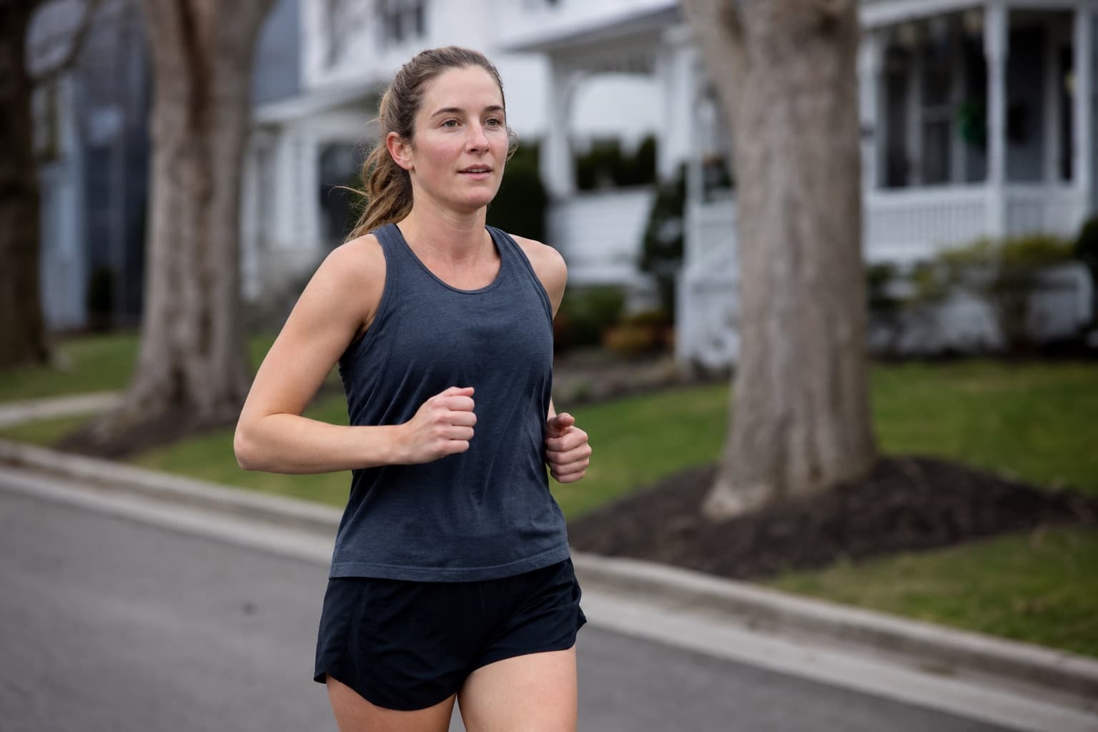 Runner on a short, easy recovery run through a quiet neighborhood.