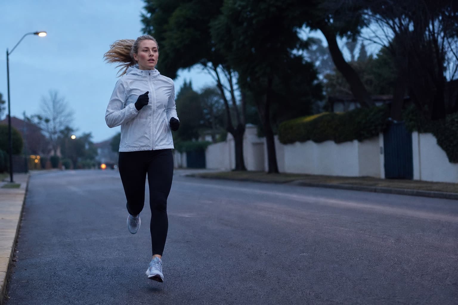 Runner on a consistent early-morning training run through a quiet suburb.