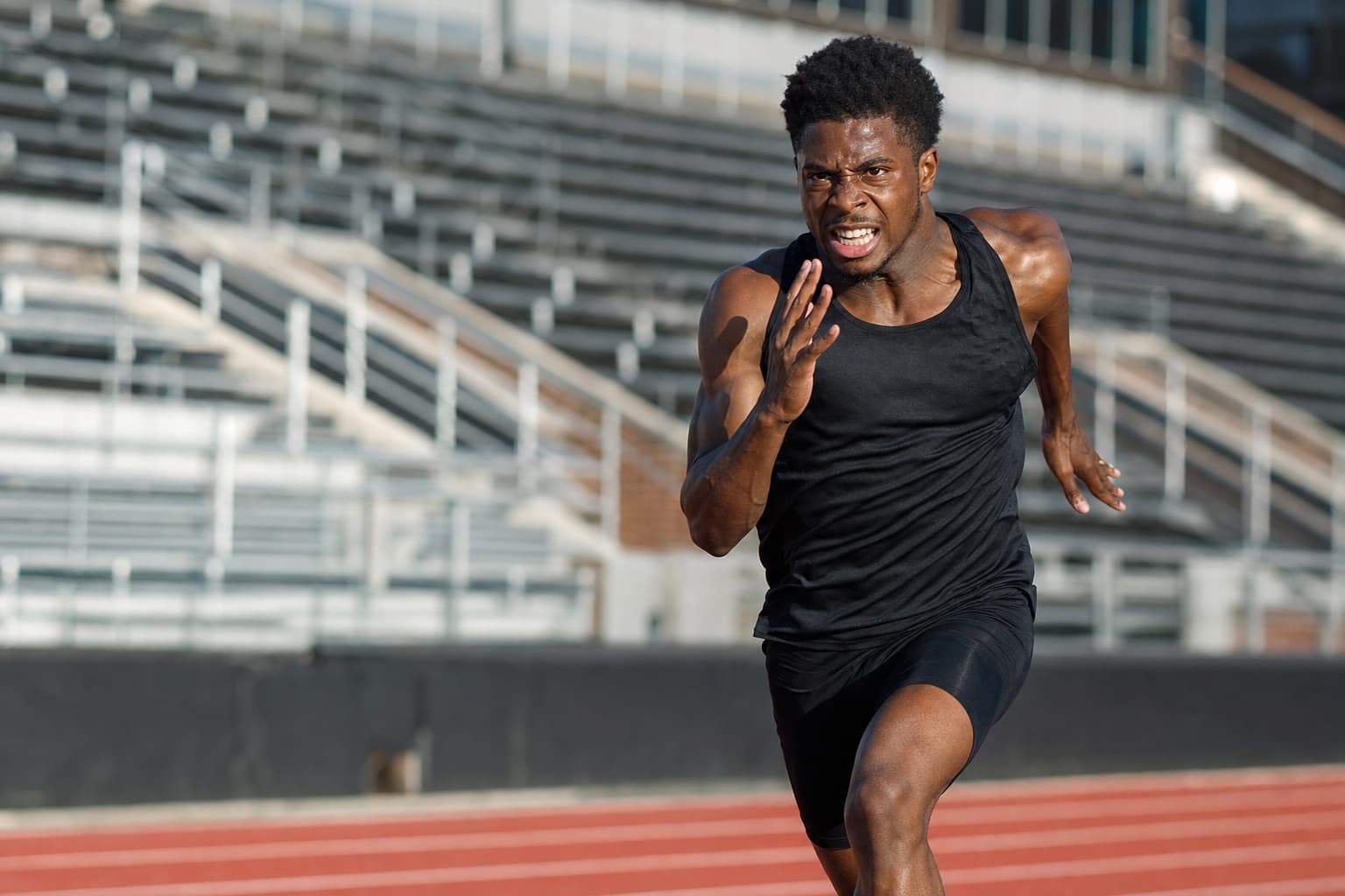 Competitive runner at near-maximal effort on a track chasing a sub-20 5K.