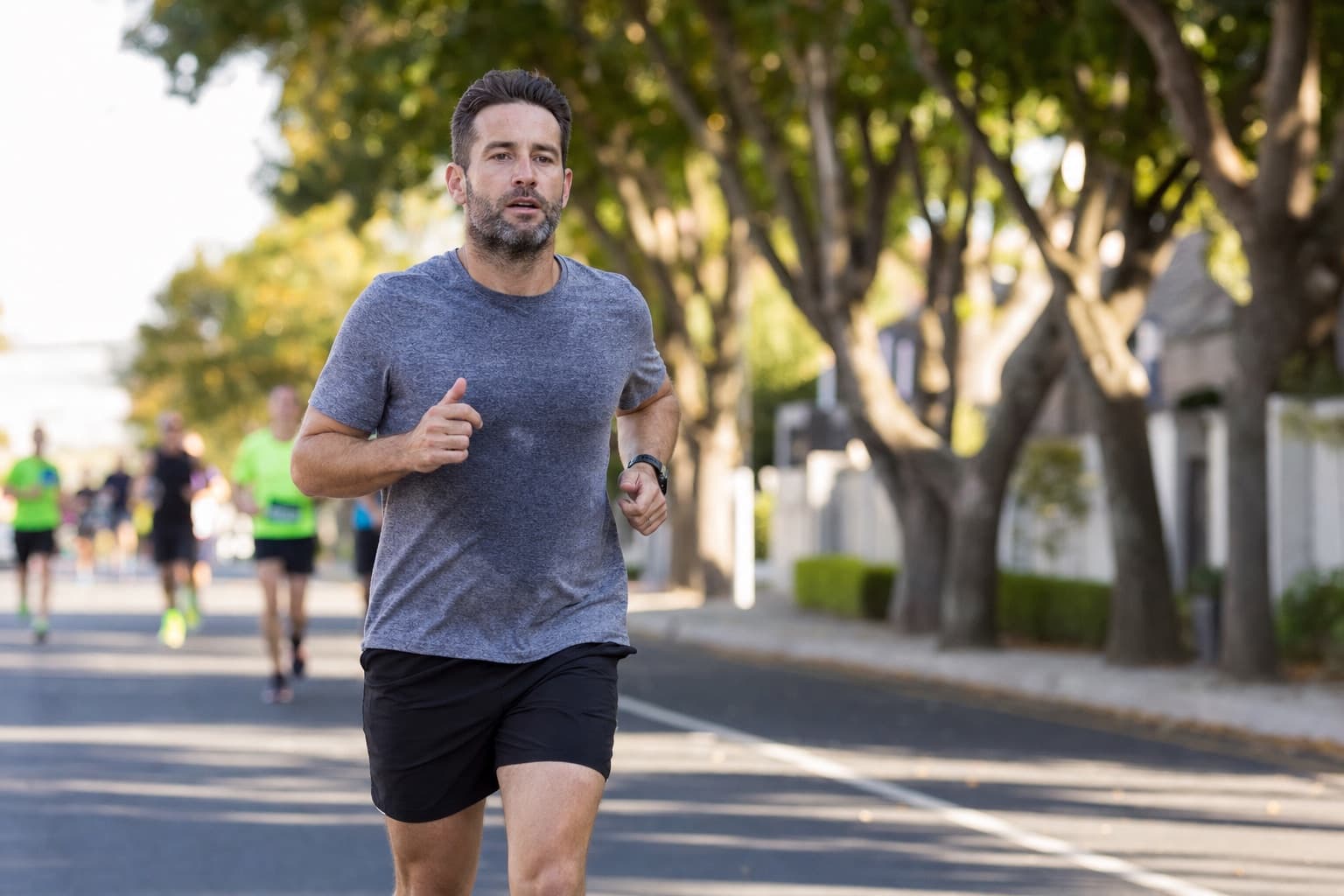 Runner holding an even, controlled effort on an open road during a 10K.