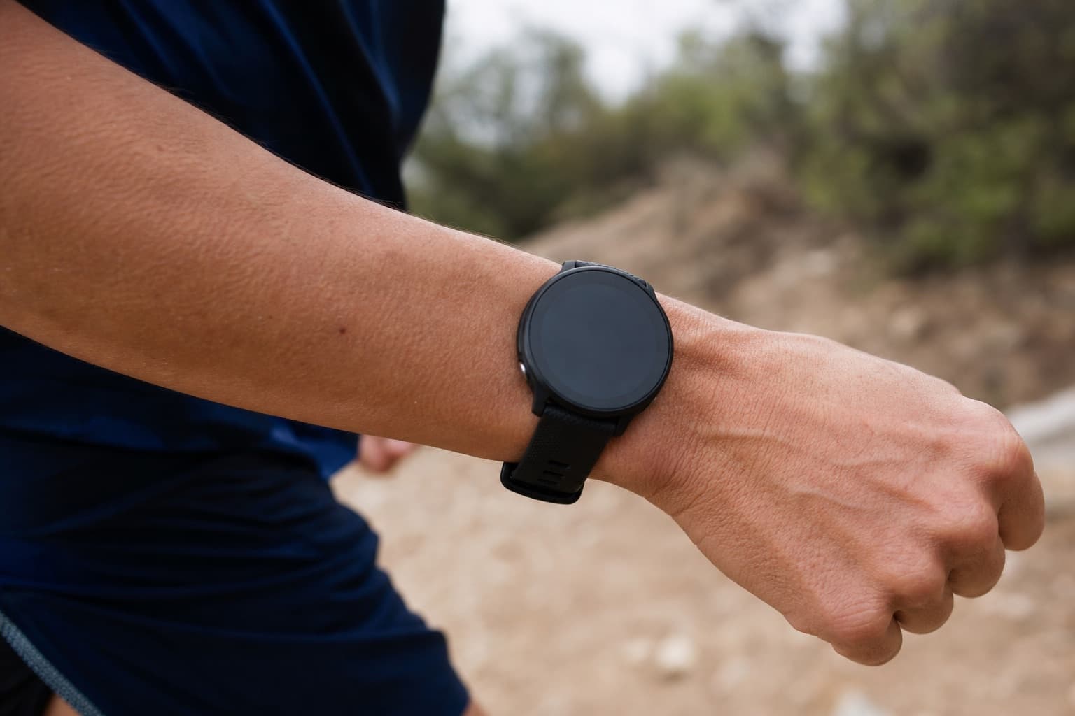 Close-up of a runner's wrist-worn GPS watch during a running stride.