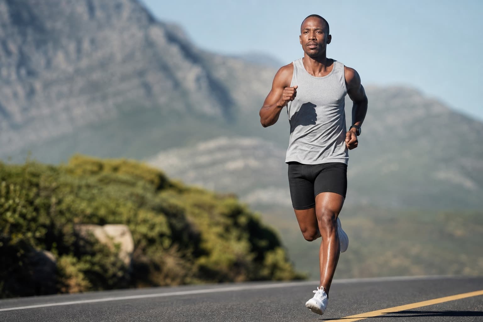 Runner with a powerful balanced stride on an open road.