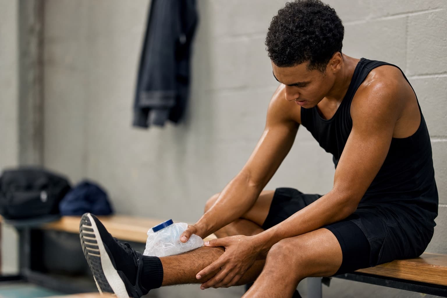 Runner icing a lower leg while resting after a comeback session.