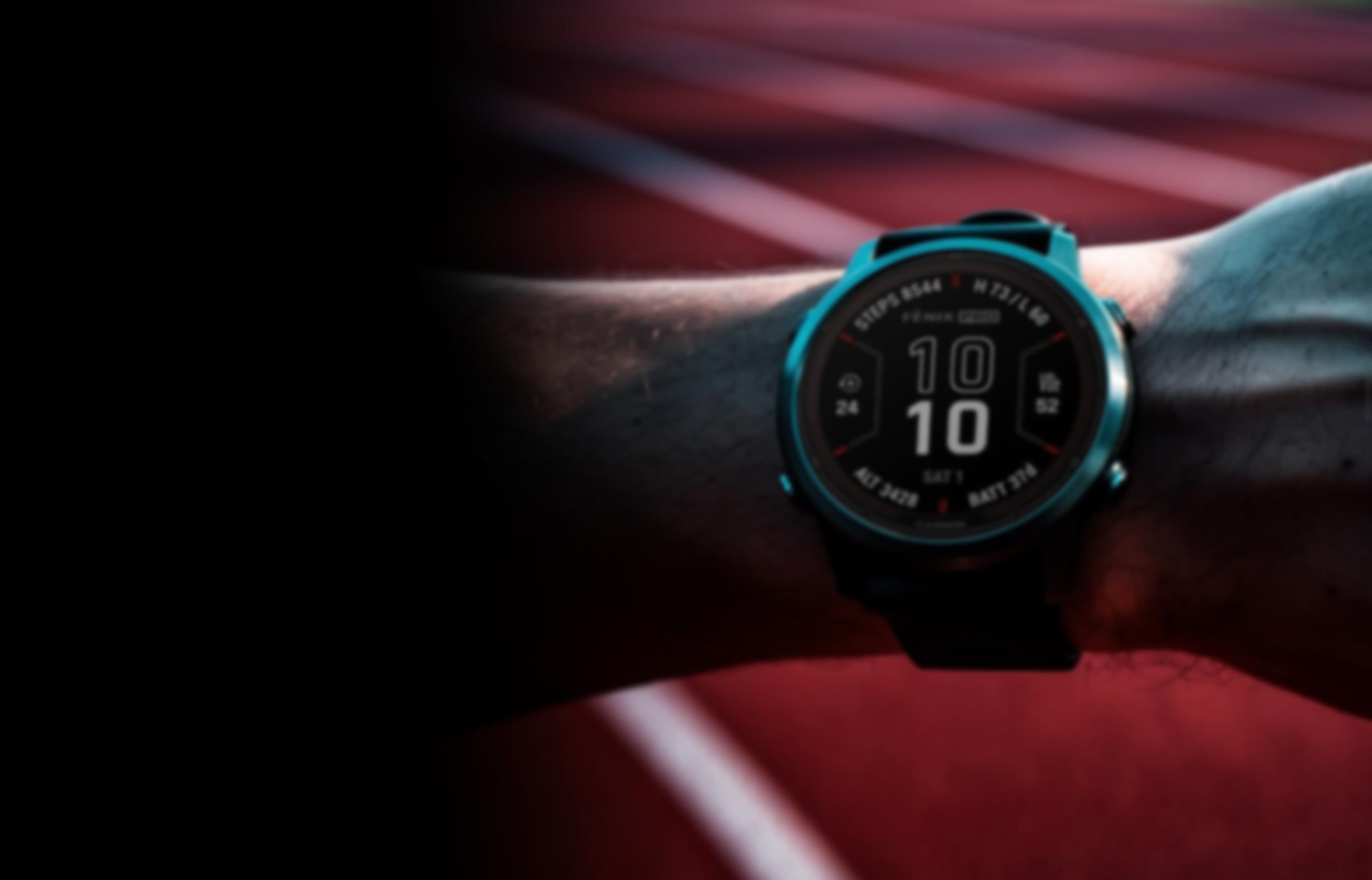 Garmin Fēnix watch on a runner's wrist with a red track in the background