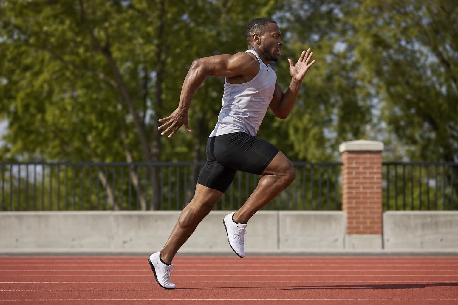 Runner showing quick, sharp speed on an outdoor track.