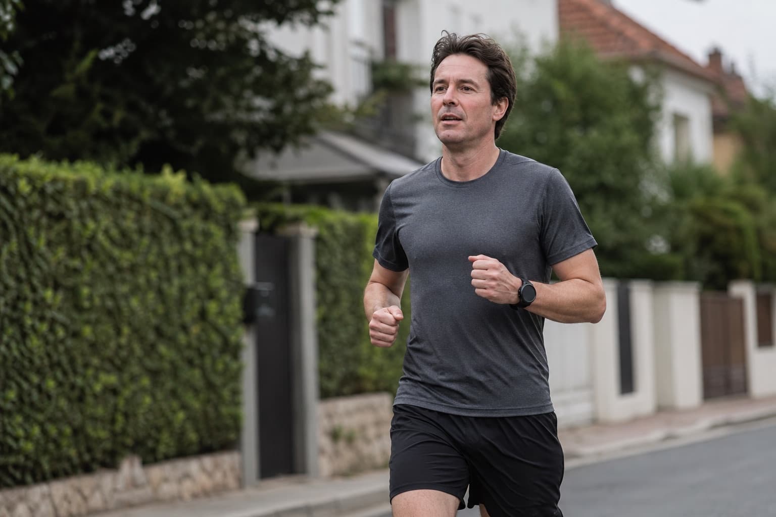 Runner on a light, easy jog through a calm residential street.