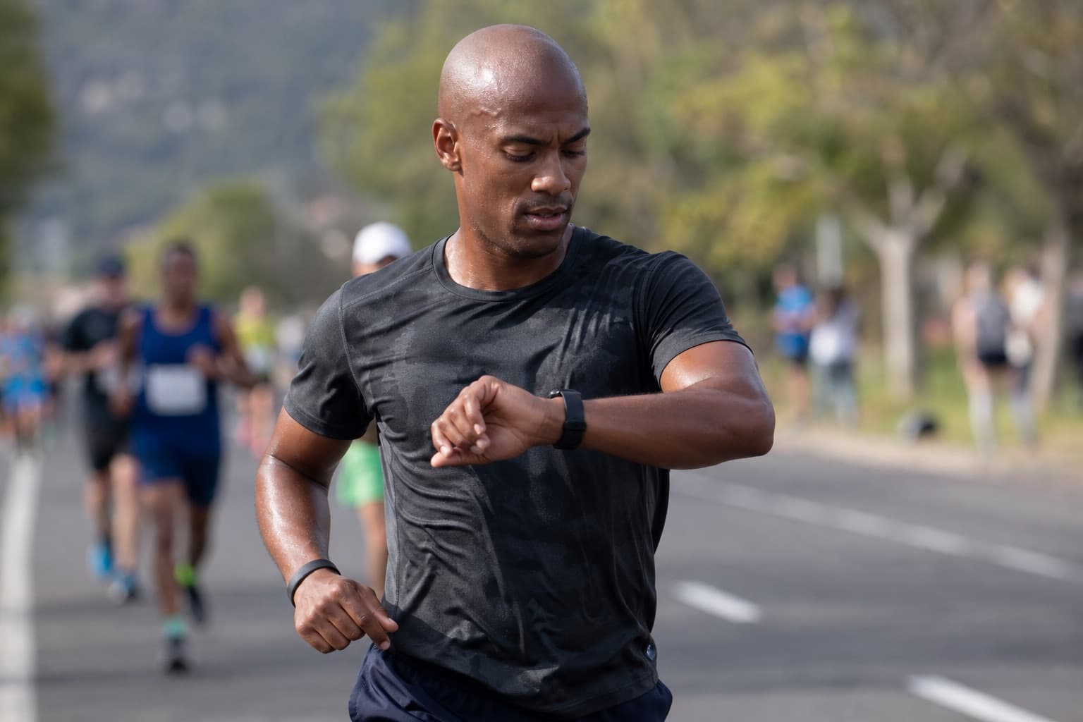Half marathon runner glancing at a wrist watch to confirm even pacing.