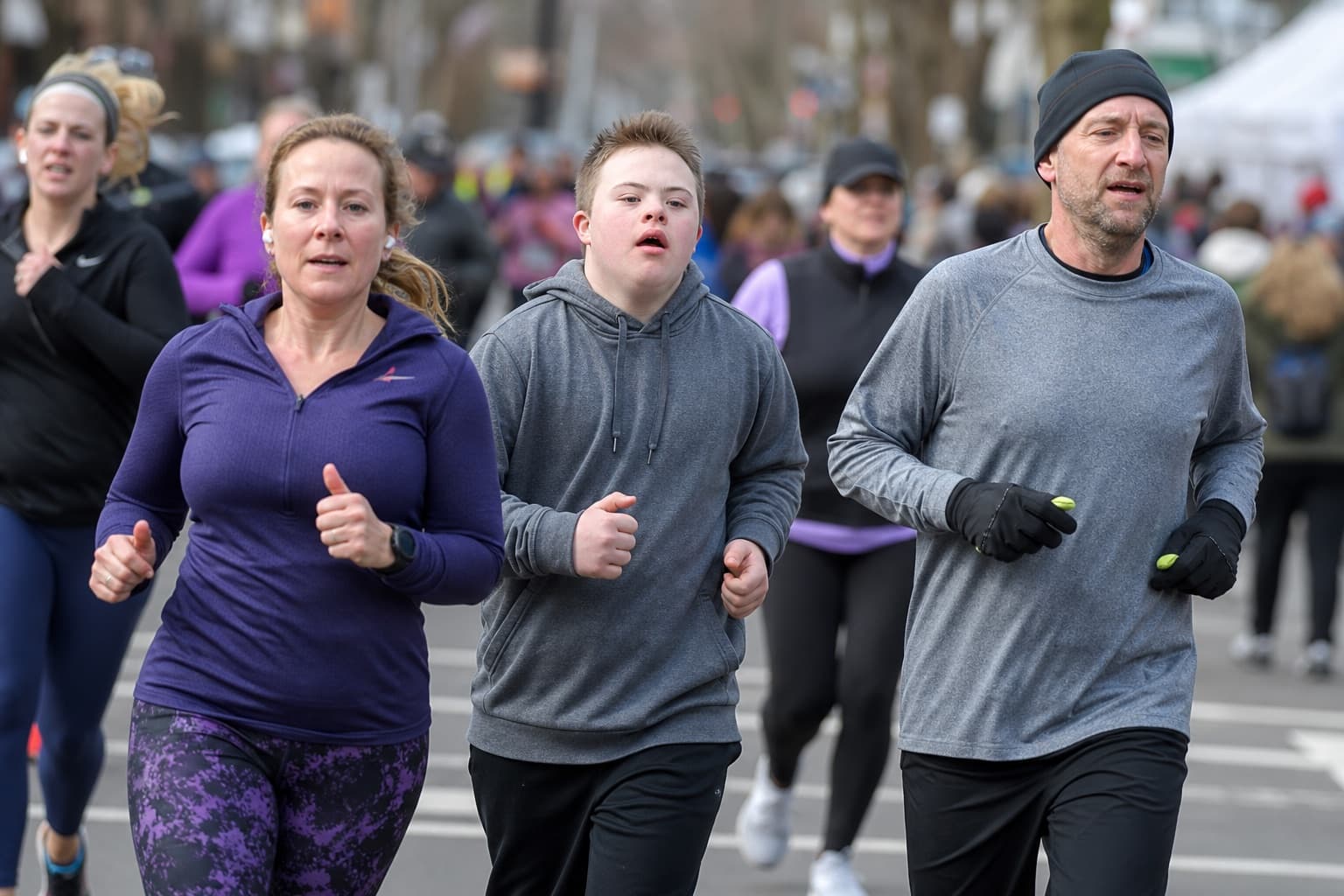 Small group of new runners jogging together at an even effort in a local race.