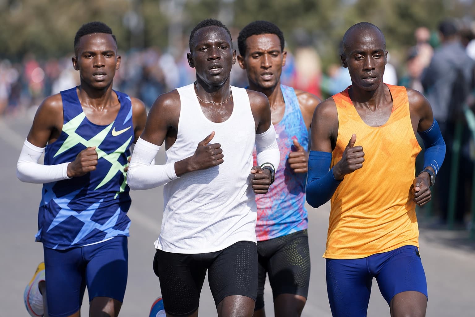 Lead chase pack of competitive 10K runners racing at a hard, even pace.