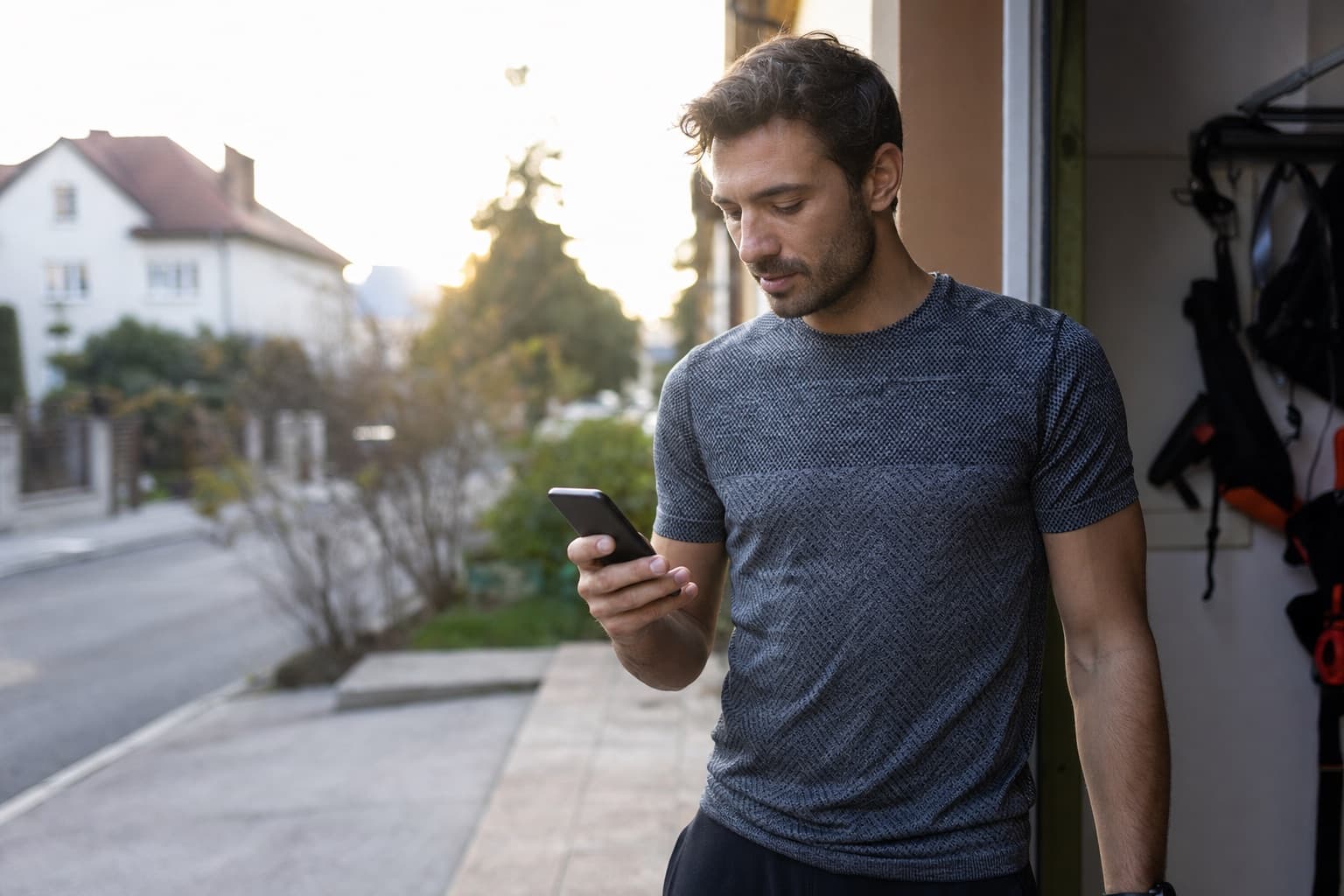 Runner checking the day's plan on a phone before heading out for a run.