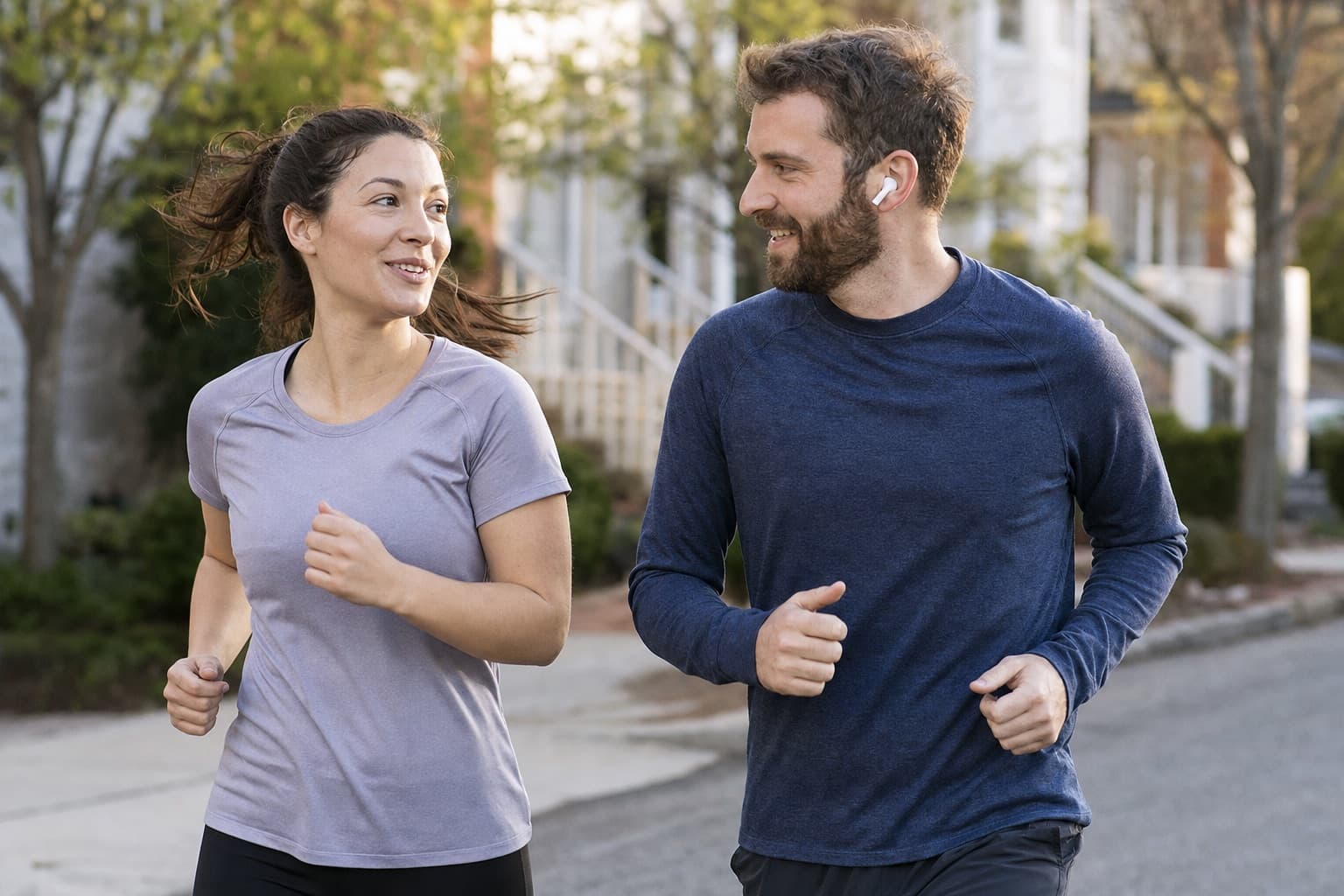 Two everyday beginners jogging together for support and accountability outdoors.