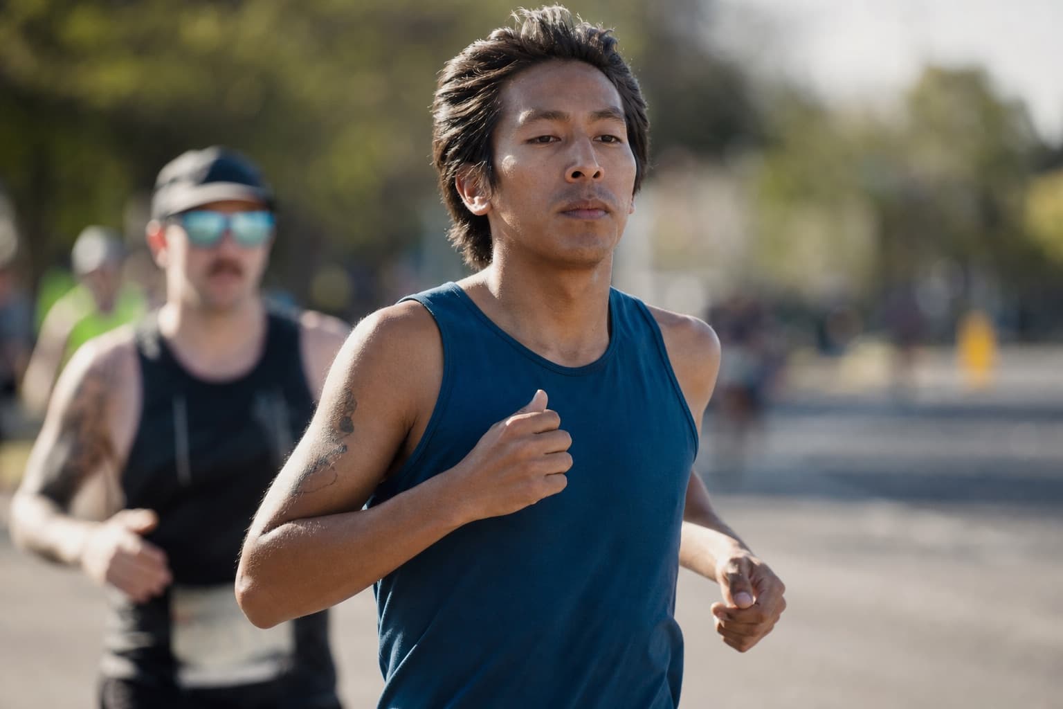 Composed runner holding a steady, relaxed effort during a race.