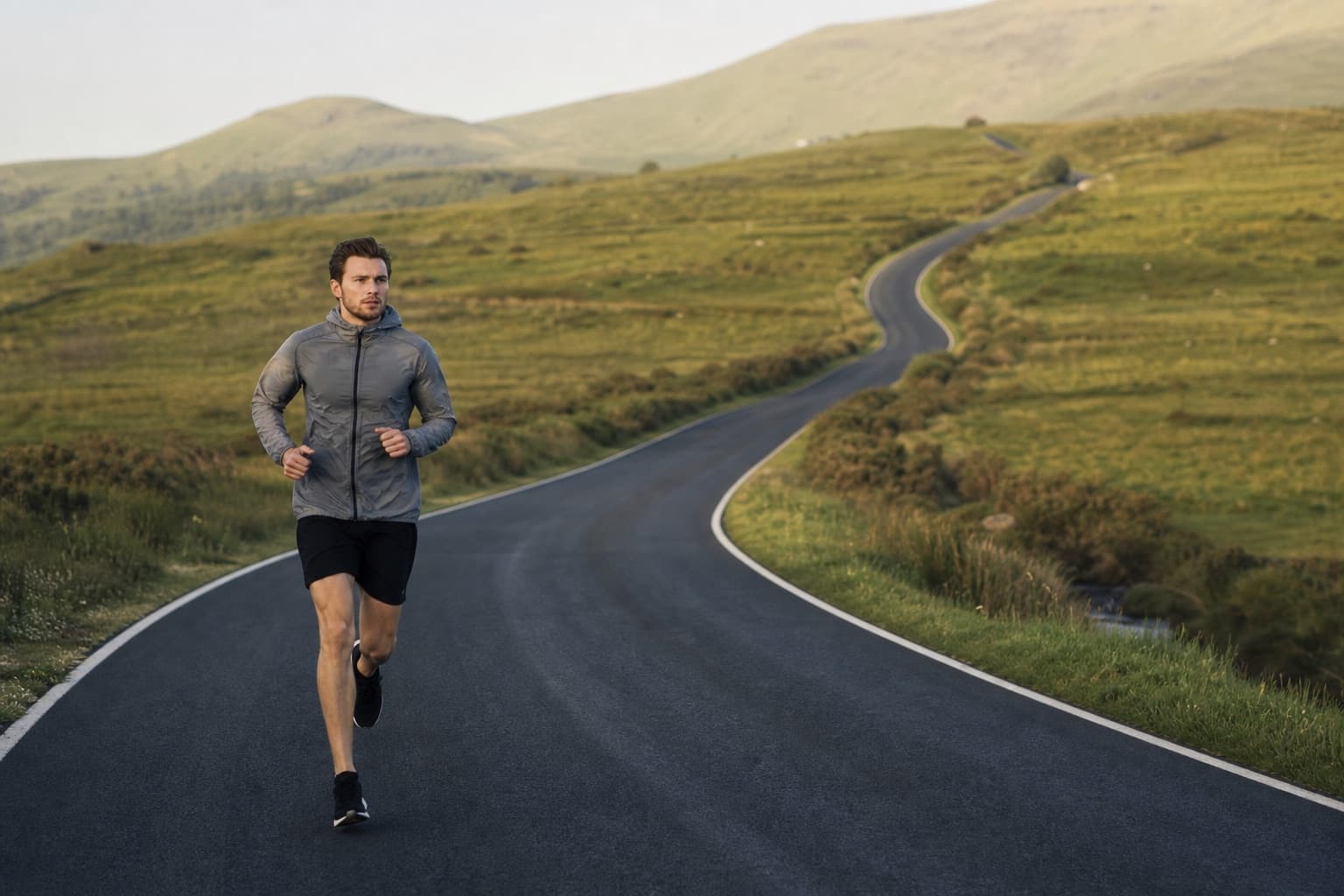Lone runner on a long quiet road through open countryside.