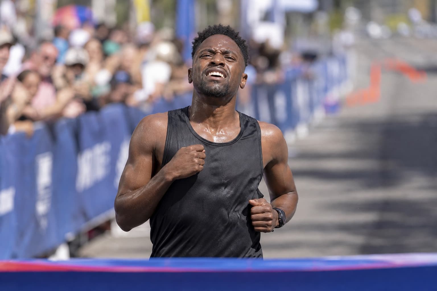 Runner finishing a half marathon with a strong, focused effort.