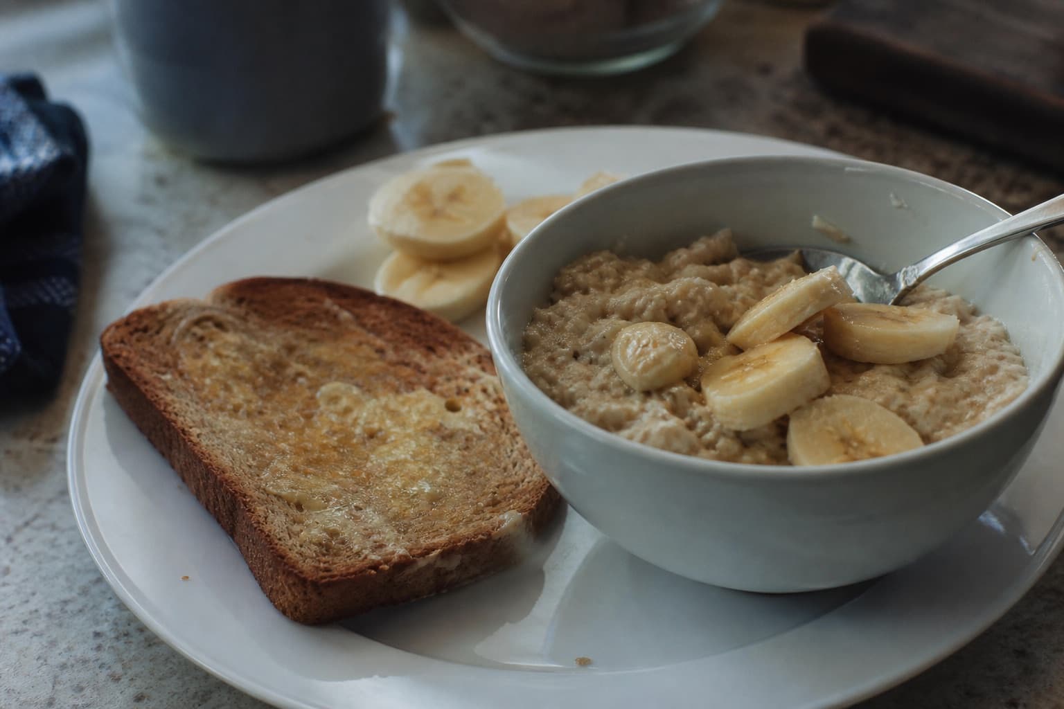 Close-up of a race-morning breakfast plate with oatmeal, banana, and toast.